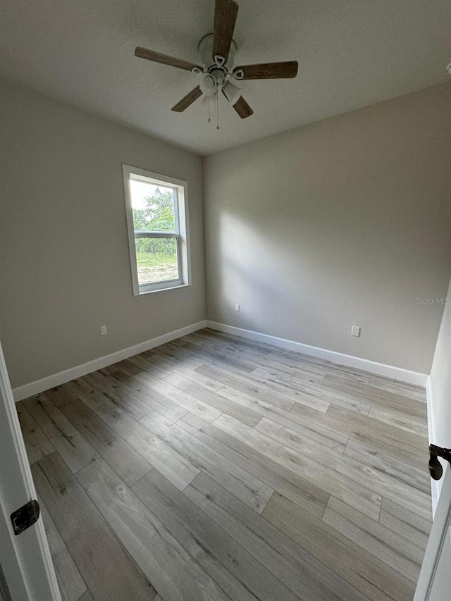 spare room with a textured ceiling, ceiling fan, and light hardwood / wood-style floors