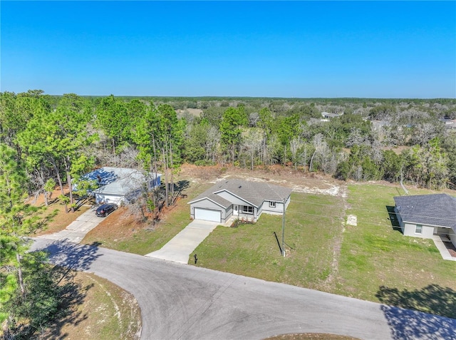 birds eye view of property featuring a view of trees