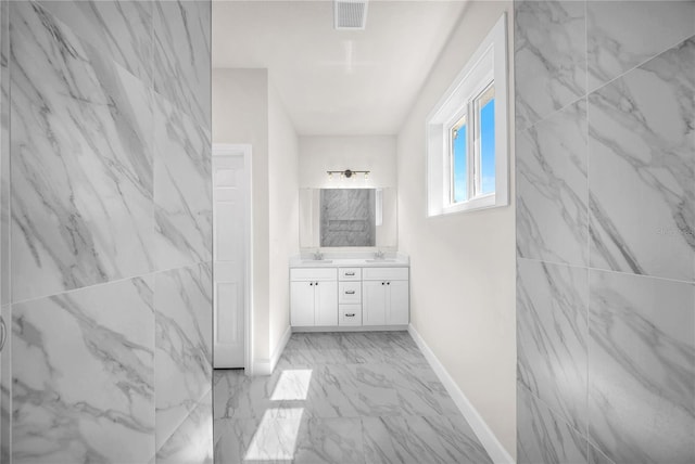 full bath with marble finish floor, visible vents, vanity, and baseboards