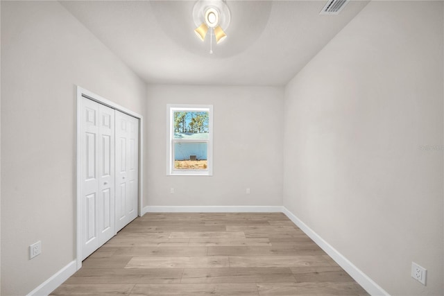 unfurnished bedroom featuring light wood-style floors, visible vents, and baseboards