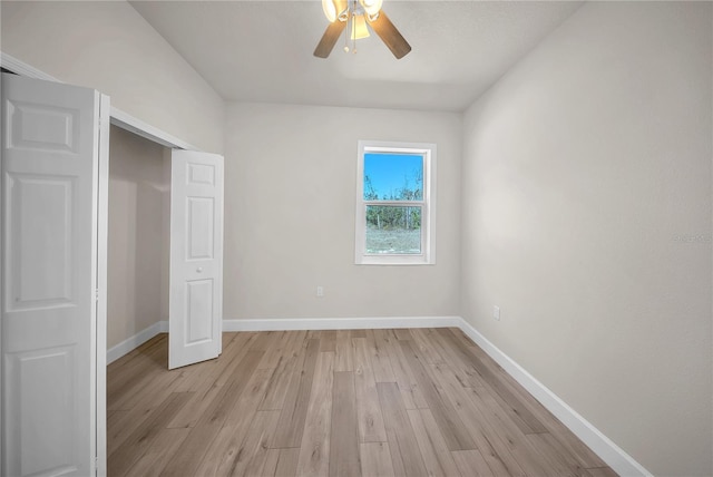 unfurnished bedroom featuring baseboards, a closet, a ceiling fan, and light wood-style floors