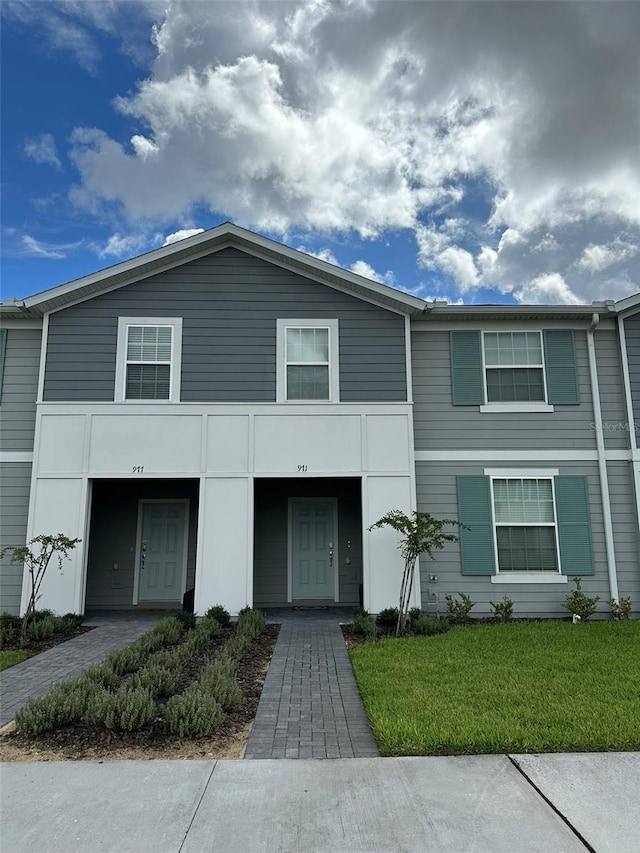 view of property with a front lawn