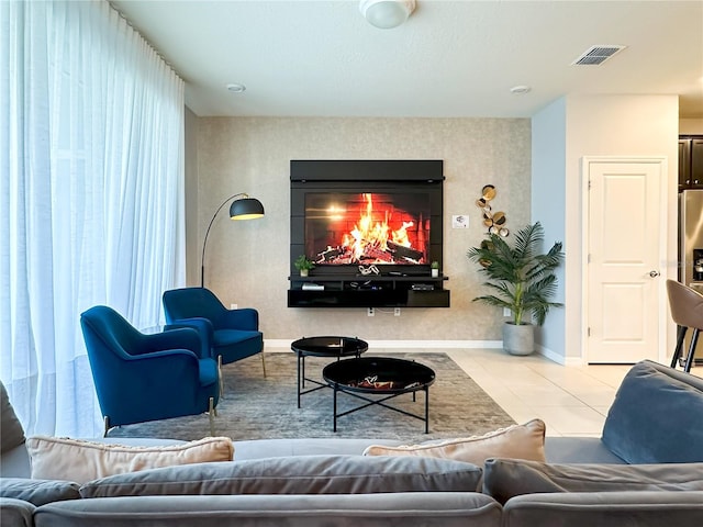 living room featuring light tile patterned floors and a fireplace