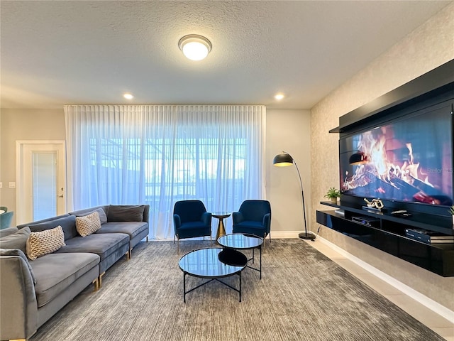 living area featuring baseboards and a textured ceiling