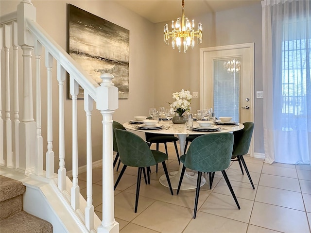 dining area featuring light tile patterned floors and a chandelier