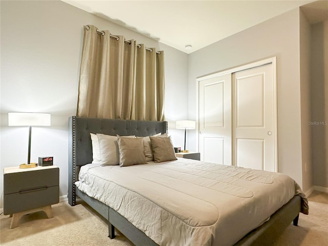 bedroom with light colored carpet and a closet