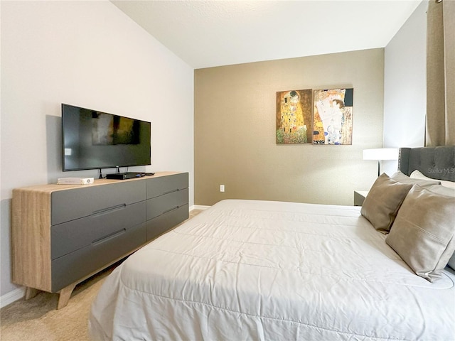 bedroom with baseboards and light carpet