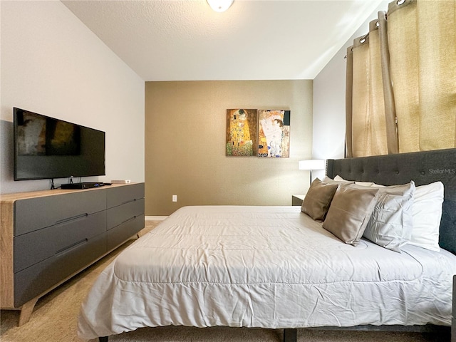 carpeted bedroom featuring a textured ceiling