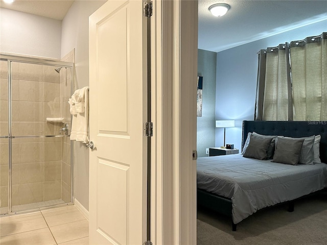 bedroom featuring a textured ceiling and light tile patterned floors