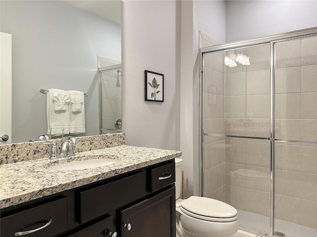 bathroom with vanity, toilet, and an enclosed shower