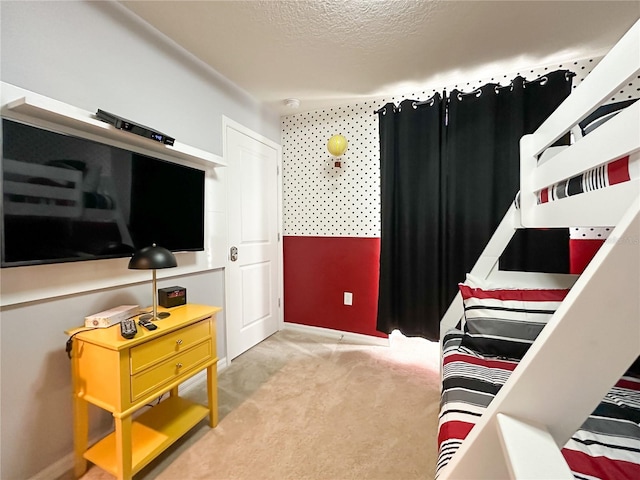 bedroom featuring light carpet and a textured ceiling