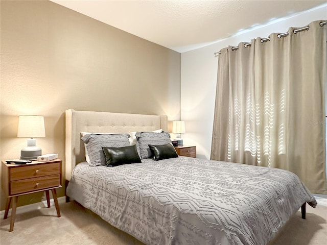 bedroom with carpet and baseboards