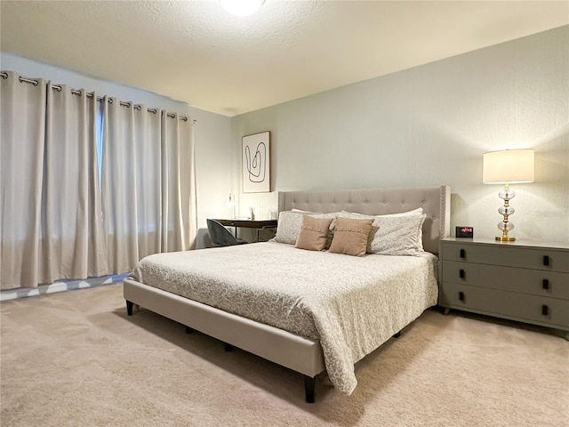 bedroom with a textured ceiling and carpet flooring