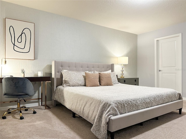 bedroom featuring a textured ceiling and carpet floors