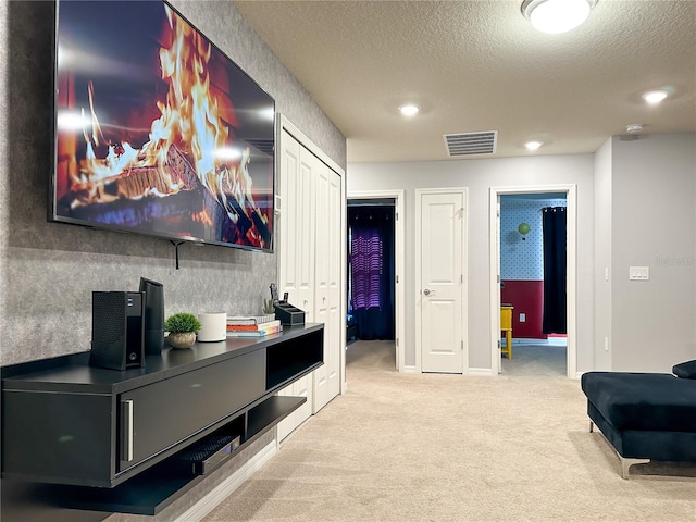 interior space featuring a textured ceiling and light colored carpet