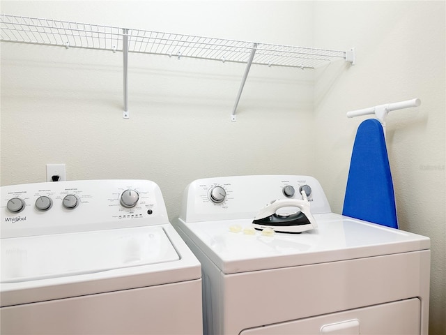 clothes washing area featuring washer and clothes dryer