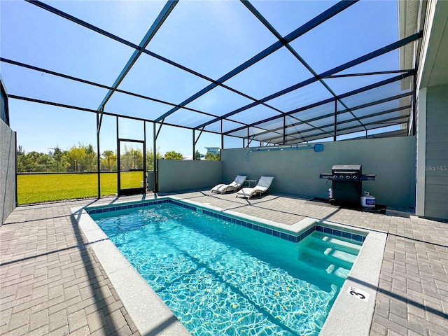 view of pool with area for grilling, a lanai, and a patio