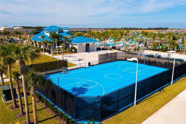 view of basketball court with a residential view, community basketball court, and fence