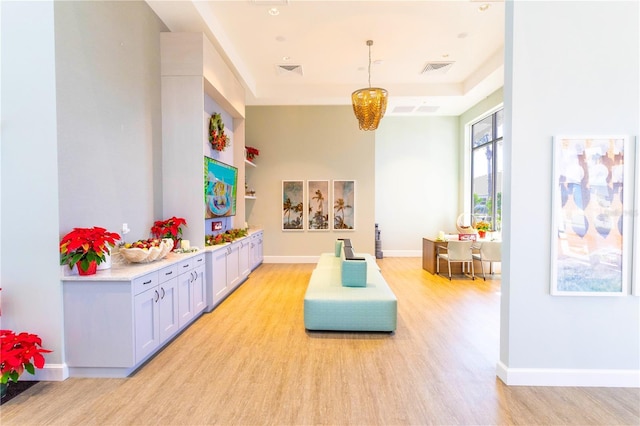 rec room with visible vents, baseboards, and light wood-style floors