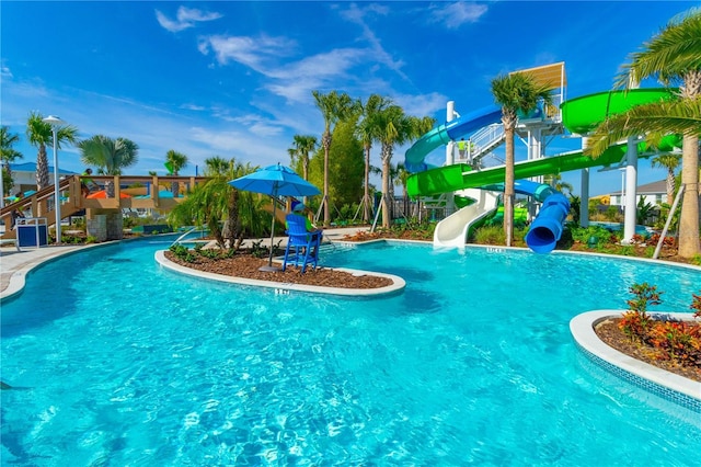 community pool featuring a water slide