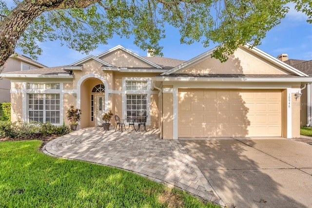 ranch-style home featuring a garage and a patio