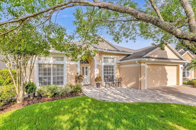 single story home with a garage and a front lawn