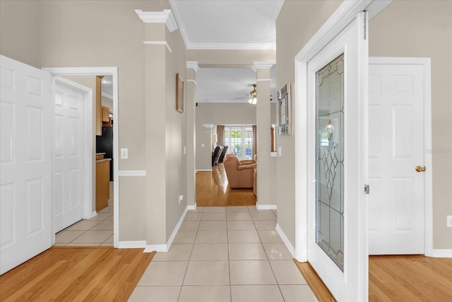 foyer entrance featuring ceiling fan, light hardwood / wood-style flooring, and ornamental molding