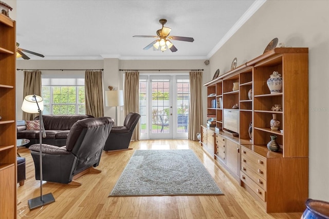 living room with light wood-type flooring, crown molding, and a healthy amount of sunlight