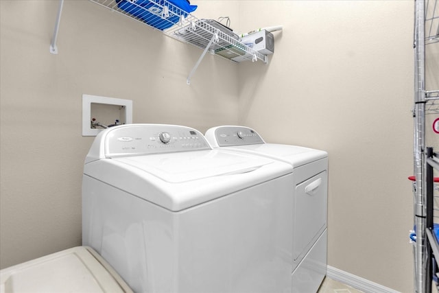 clothes washing area featuring washer and clothes dryer