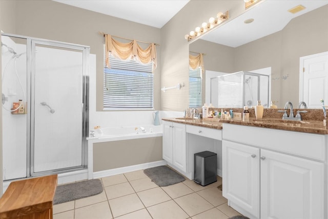 bathroom with tile patterned flooring, shower with separate bathtub, and vanity