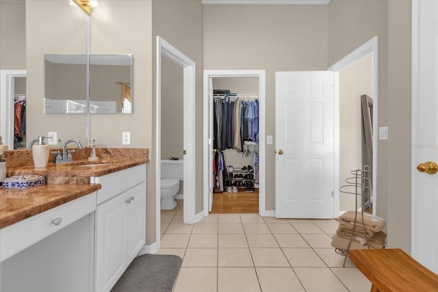 bathroom featuring tile patterned flooring, vanity, and toilet