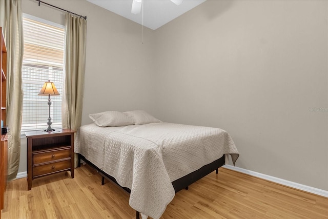 bedroom featuring light hardwood / wood-style floors and ceiling fan