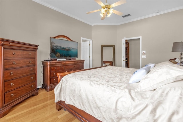 bedroom featuring light hardwood / wood-style flooring, ceiling fan, and ornamental molding