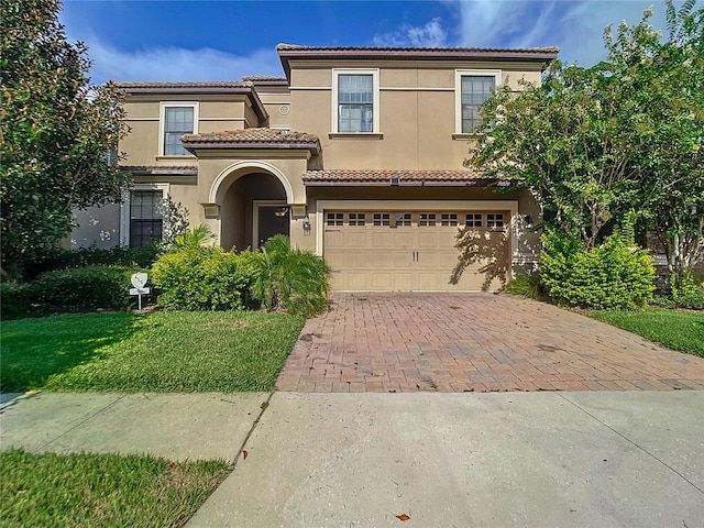 mediterranean / spanish-style house with a garage