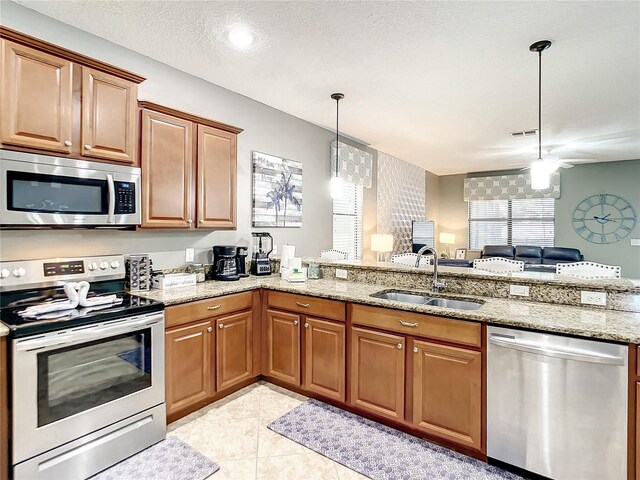 1410 Wexford Way, Davenport, FL 33896 - kitchen with open floor plan, a peninsula, appliances with stainless steel finishes, pendant lighting, and a sink