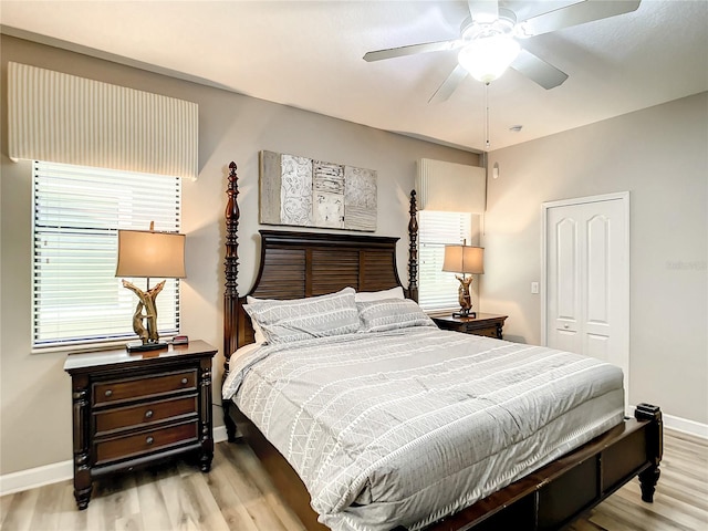 bedroom with light wood-type flooring, a closet, and ceiling fan