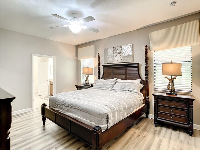 1410 Wexford Way, Davenport, FL 33896 - bedroom with ensuite bathroom, baseboards, a ceiling fan, and wood finished floors