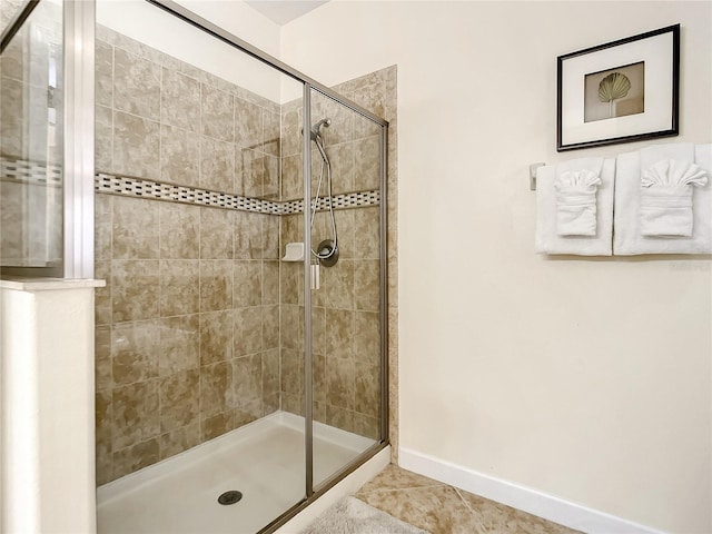 bathroom with a shower with shower door and tile patterned floors