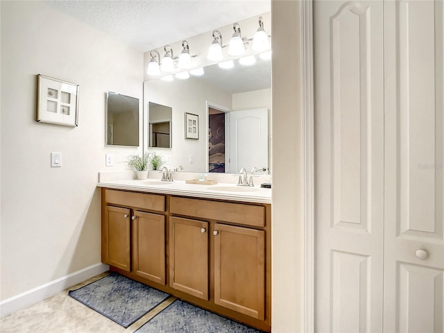 bathroom featuring vanity, a textured ceiling, and tile patterned floors