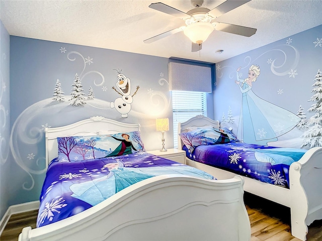 bedroom featuring ceiling fan, wood-type flooring, and a textured ceiling