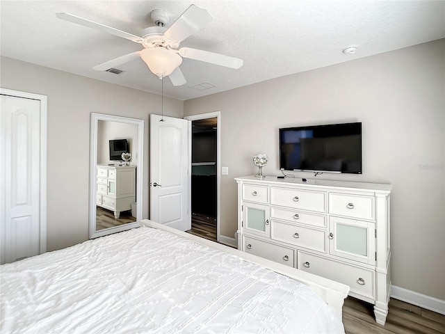 bedroom with ceiling fan and hardwood / wood-style flooring