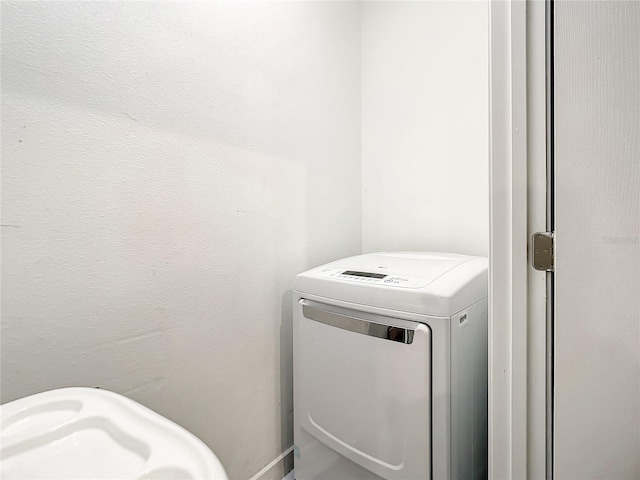 clothes washing area featuring washer / dryer