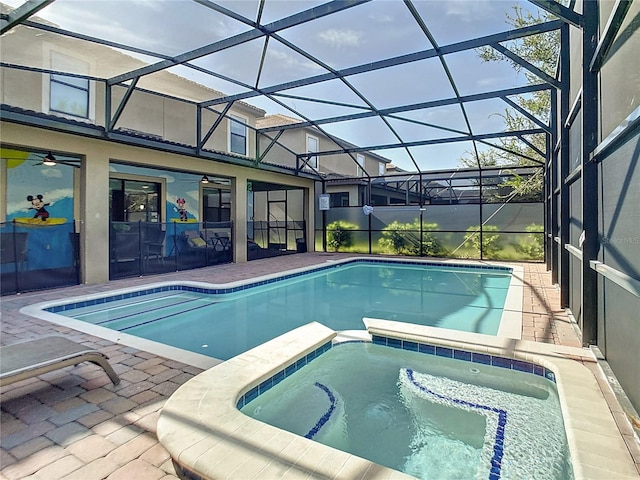 view of swimming pool with glass enclosure, a patio, and an in ground hot tub