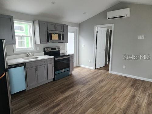 575 2nd St, Oviedo, FL 32765 - kitchen featuring dark hardwood / wood-style flooring, sink, gray cabinetry, an AC wall unit, and stainless steel appliances