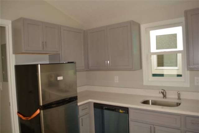 575 2nd St, Oviedo, FL 32765 - kitchen featuring sink, gray cabinetry, stainless steel appliances, and vaulted ceiling