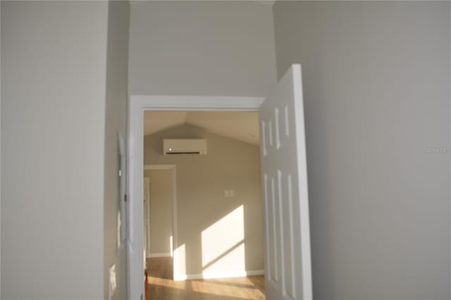 575 2nd St, Oviedo, FL 32765 - hall with light wood-type flooring, lofted ceiling, and a wall mounted air conditioner
