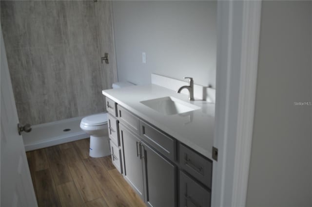 575 2nd St, Oviedo, FL 32765 - bathroom featuring hardwood / wood-style flooring, toilet, vanity, and a shower