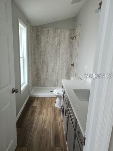 575 2nd St, Oviedo, FL 32765 - bathroom with hardwood / wood-style flooring, toilet, a wealth of natural light, and vanity