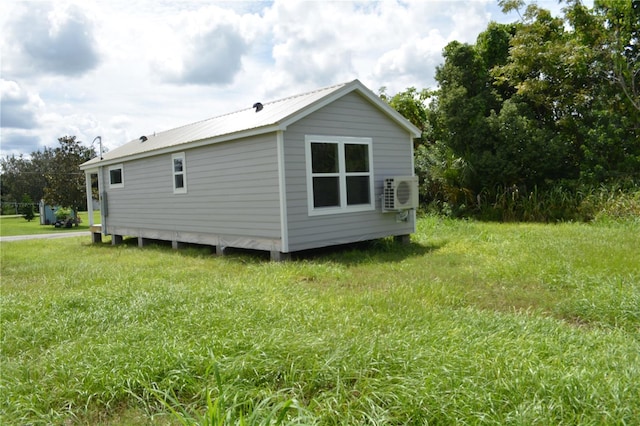 575 2nd St, Oviedo, FL 32765 - view of side of property featuring ac unit and a lawn