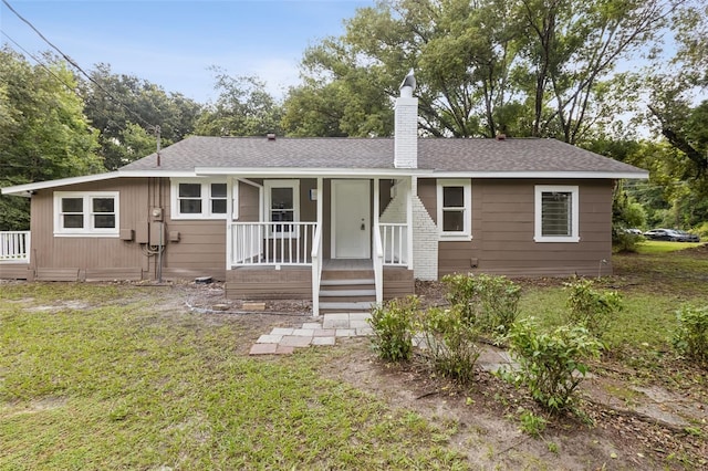 ranch-style home featuring a front yard and a porch